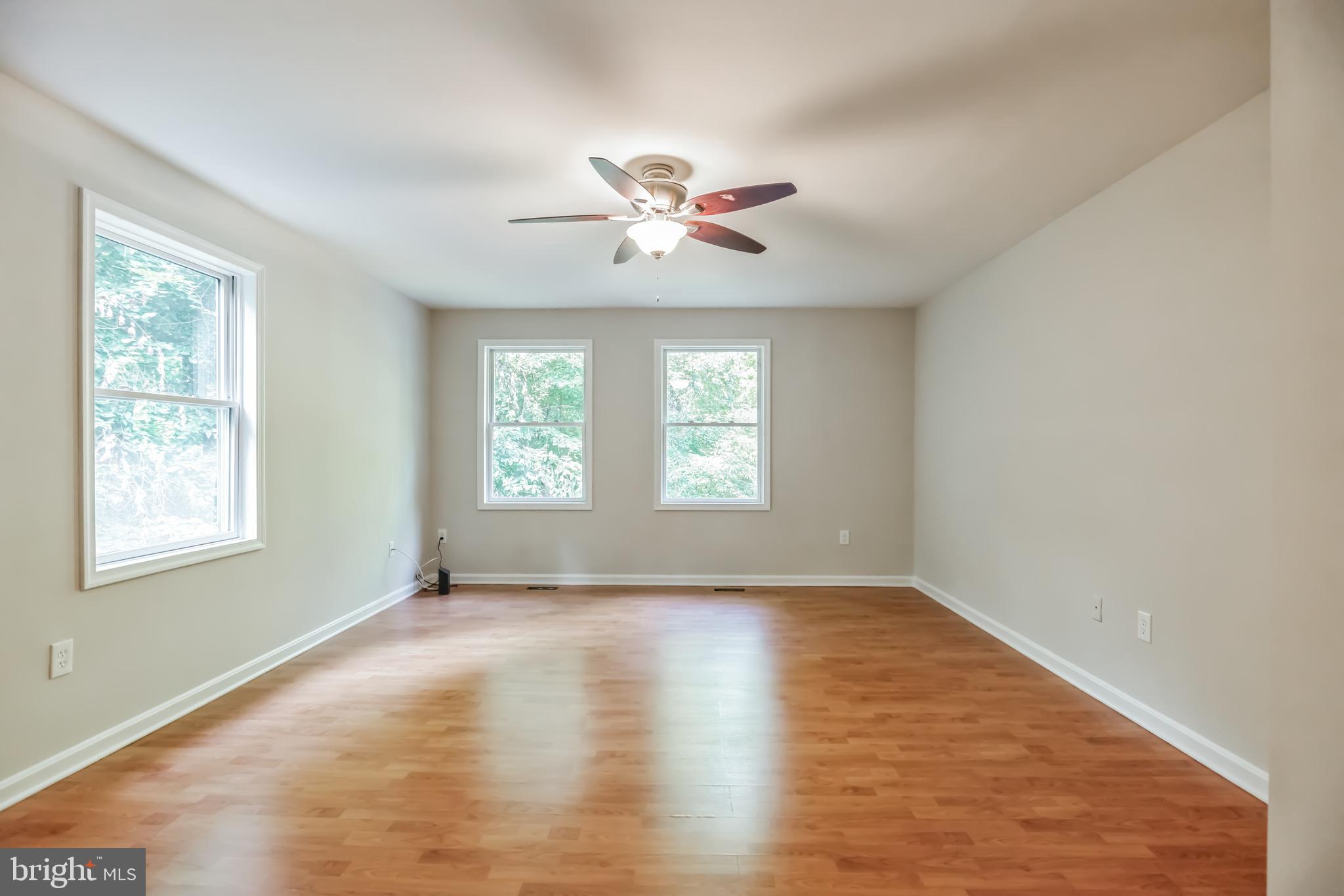4365 Harvey Road Huntingtown, MD 20639 - Photo 22 of 36 a view of an empty room with window and wooden floor