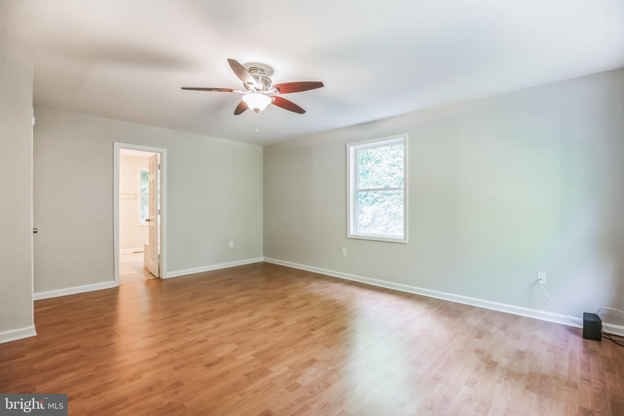 4365 Harvey Road Huntingtown, MD 20639 - Photo 24 of 36 a view of an empty room with wooden floor and a window