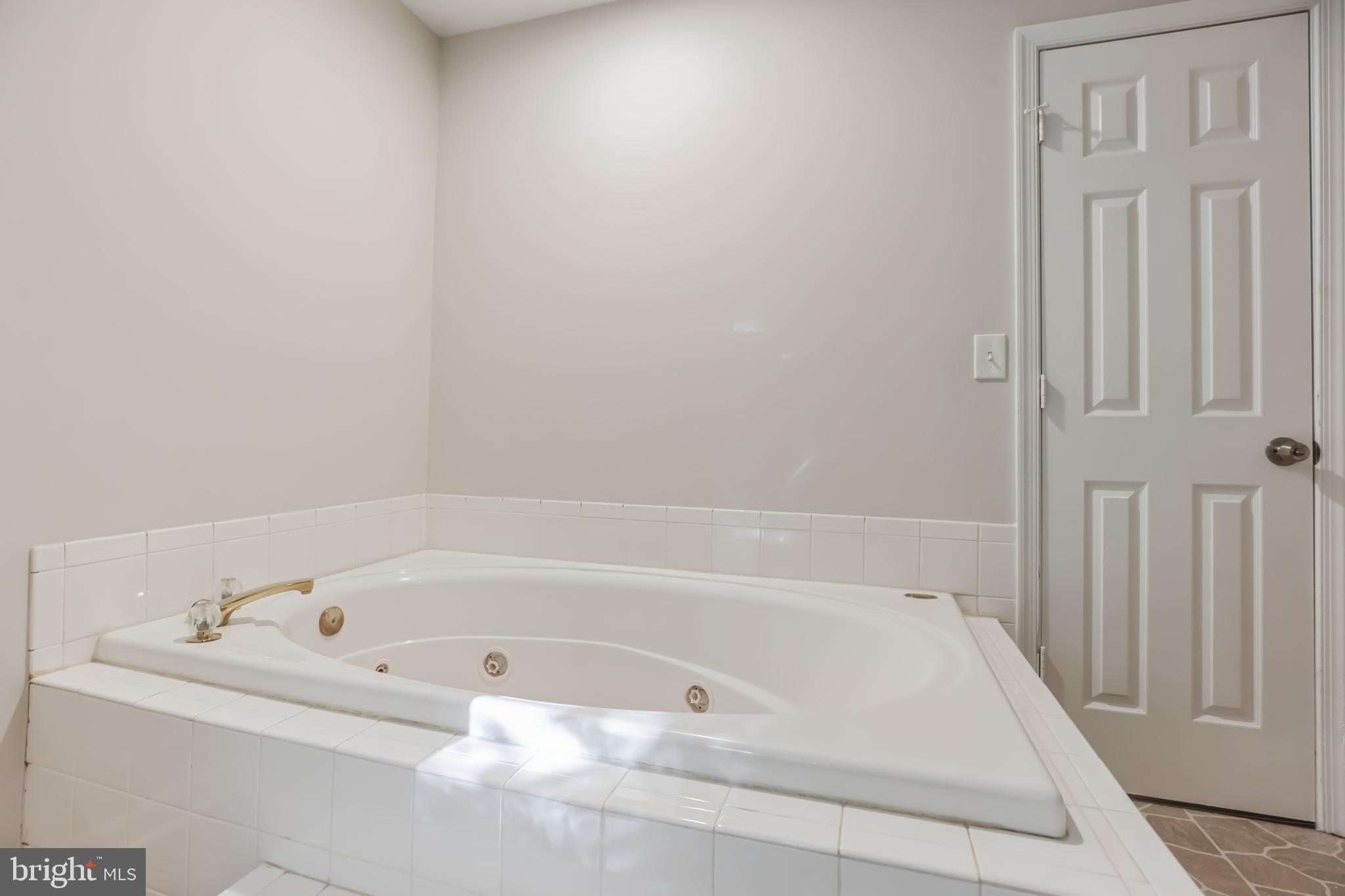 4365 Harvey Road Huntingtown, MD 20639 - Photo 28 of 36 a bathroom with bathtub and shower