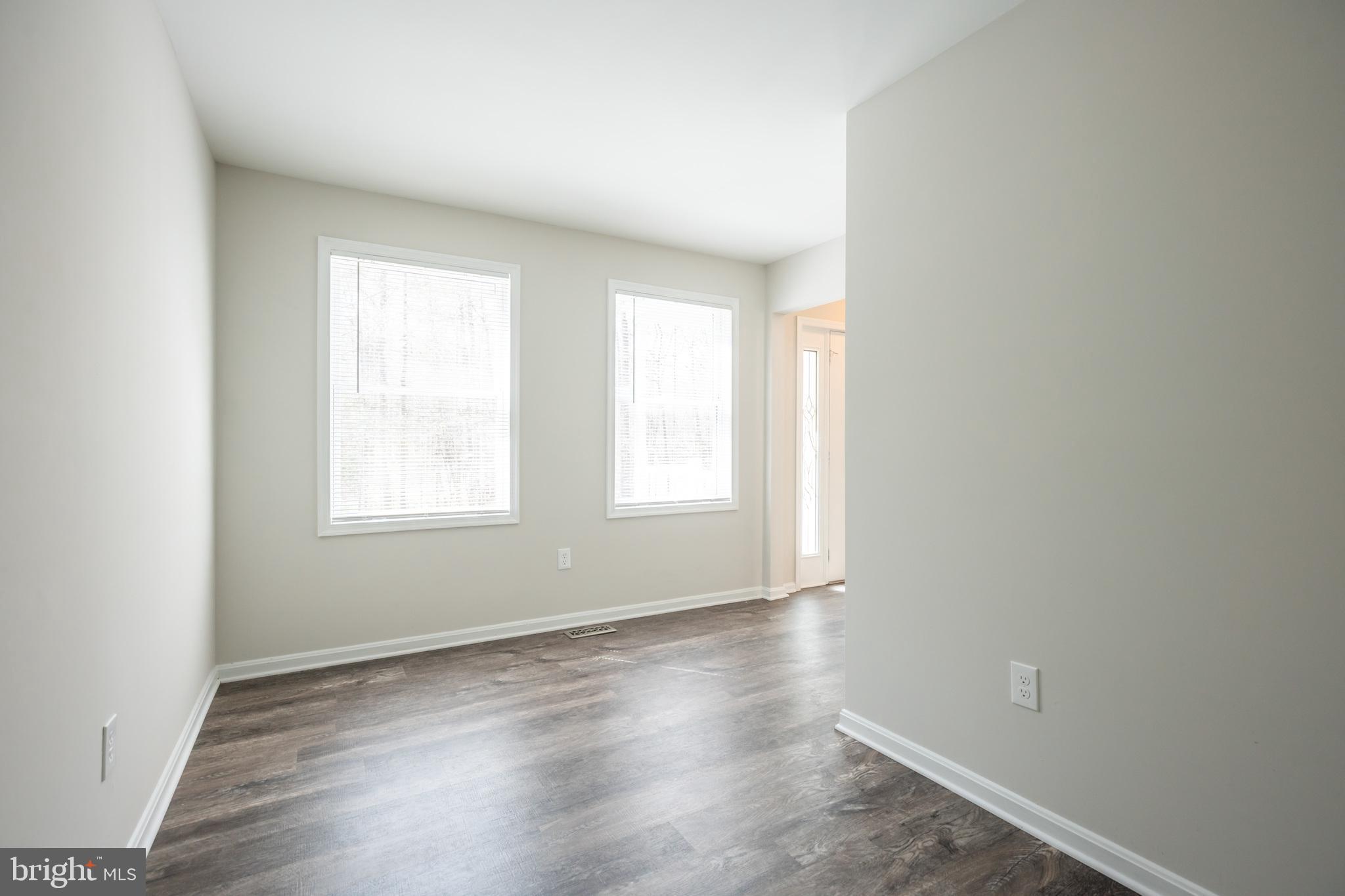 4365 Harvey Road Huntingtown, MD 20639 - Photo 9 of 36 an empty room with wooden floor and windows