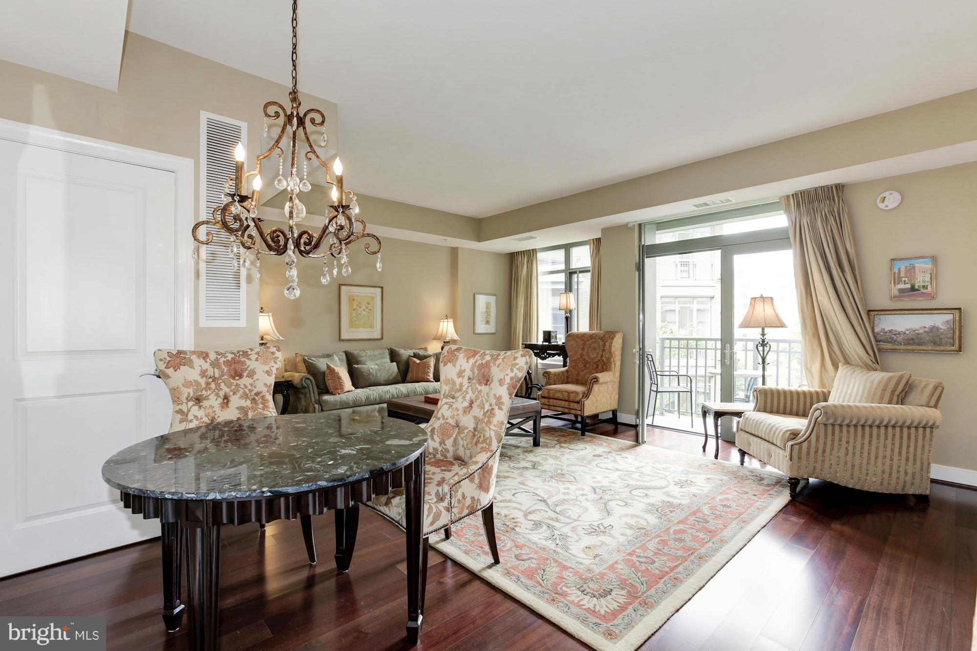 2425 L Street Northwest, Unit 412 Washington, DC 20037 - Photo 2 of 28 a living room with furniture and a chandelier