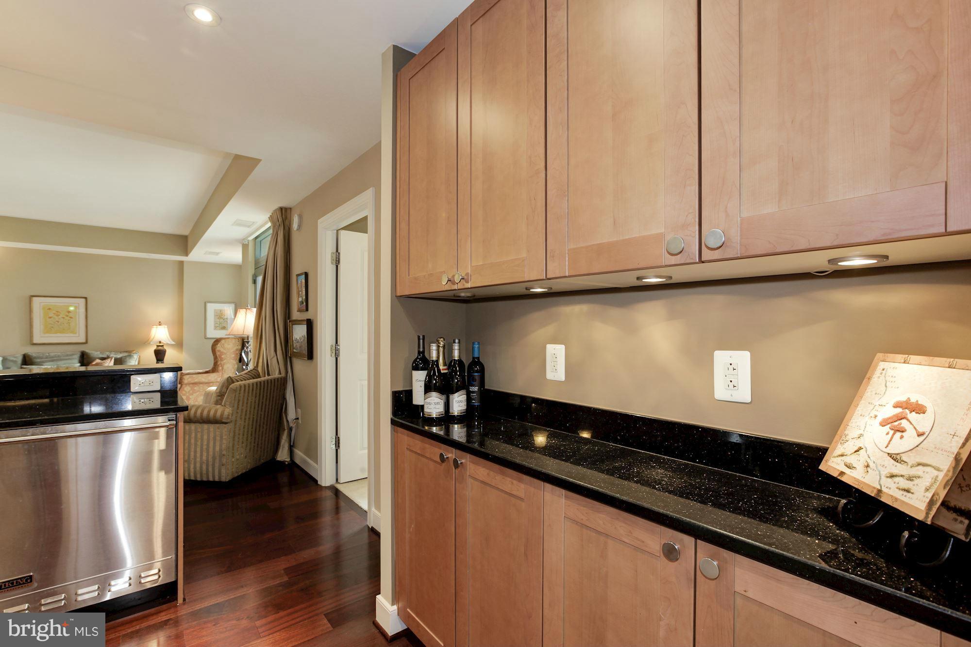 2425 L Street Northwest, Unit 412 Washington, DC 20037 - Photo 12 of 28 a kitchen with a refrigerator and cabinets