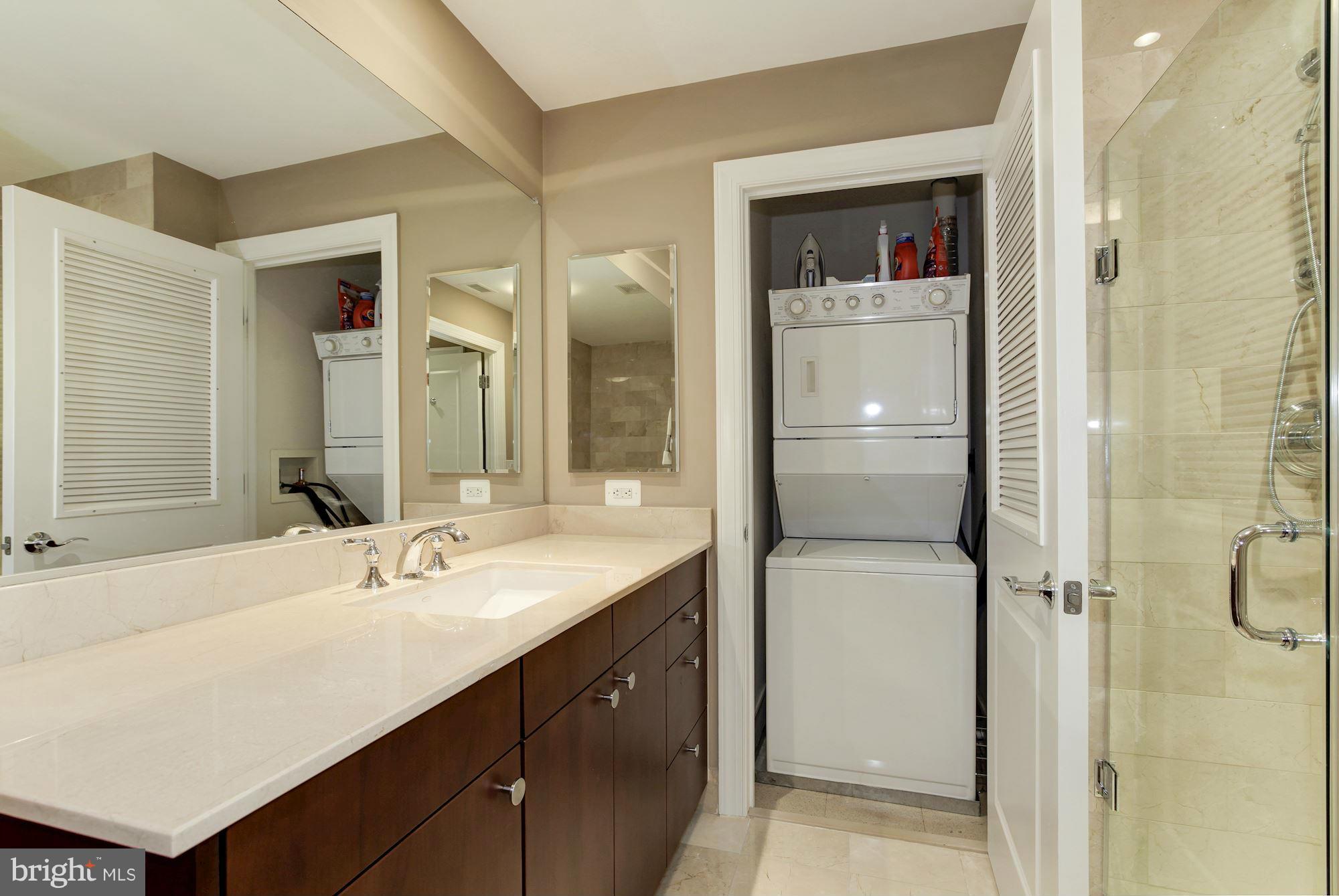 2425 L Street Northwest, Unit 412 Washington, DC 20037 - Photo 17 of 28 a bathroom with a double vanity sink mirror and shower