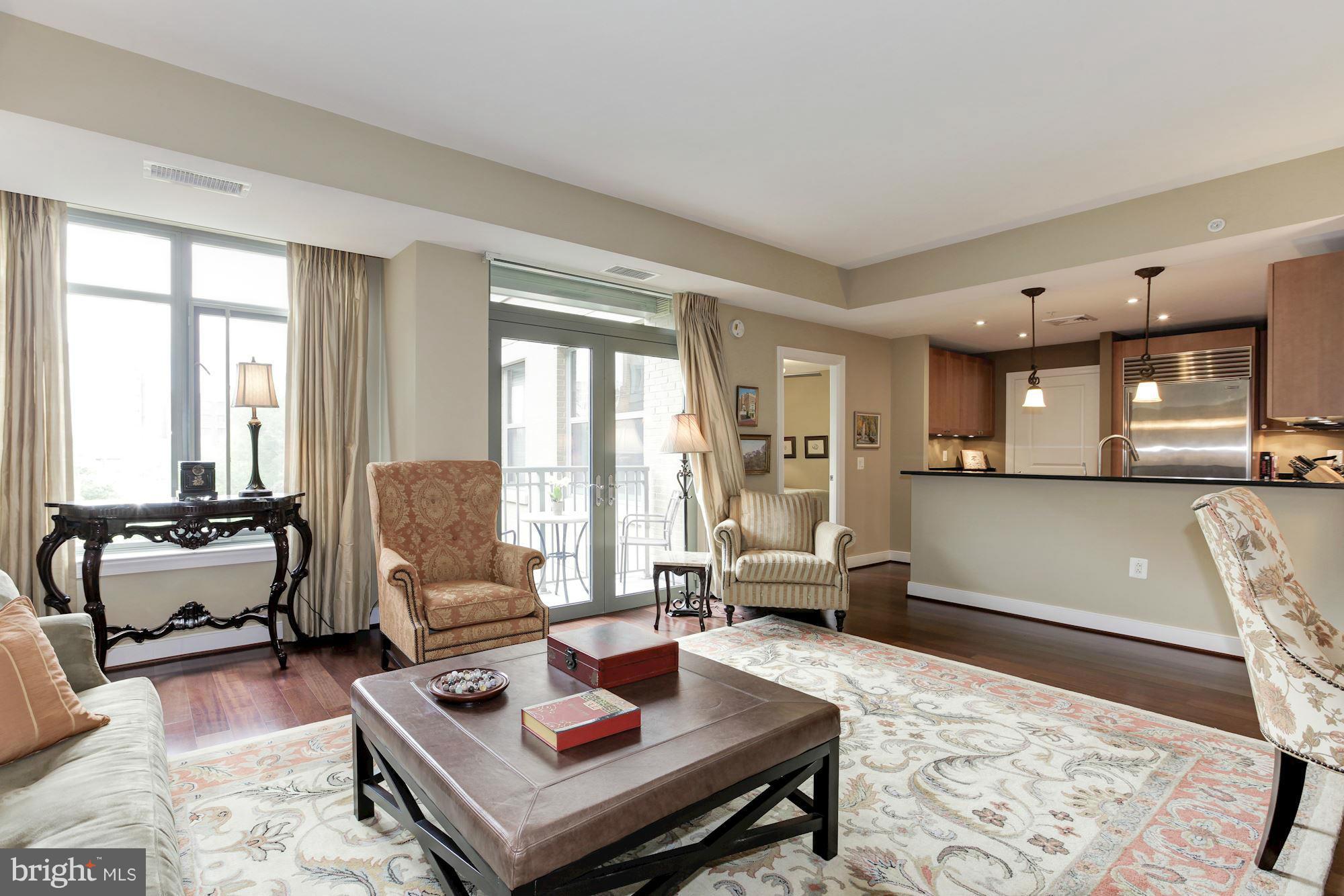 2425 L Street Northwest, Unit 412 Washington, DC 20037 - Photo 4 of 28 a living room with furniture and large windows