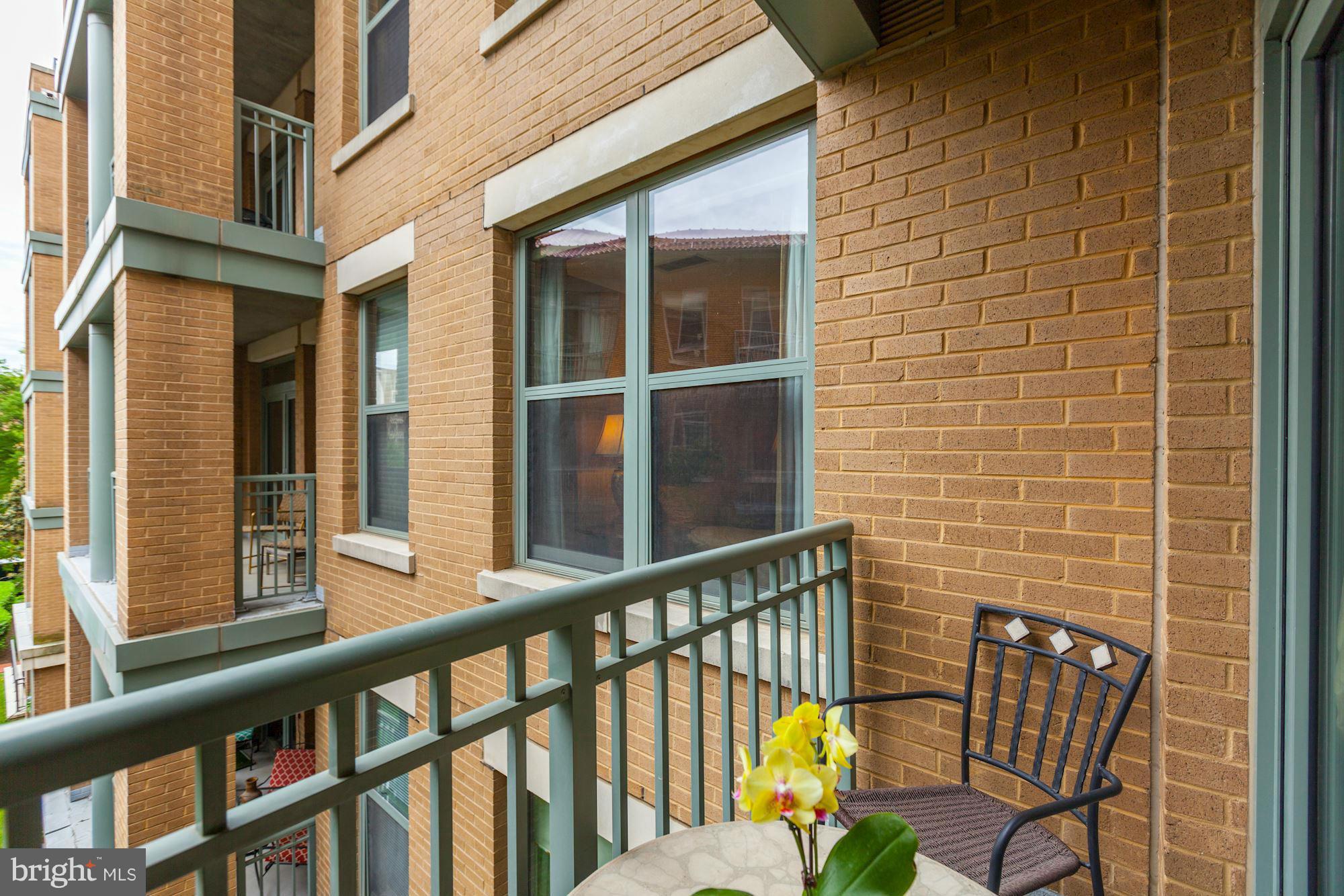 2425 L Street Northwest, Unit 412 Washington, DC 20037 - Photo 5 of 28 a view of a brick wall with a chair and table in the balcony