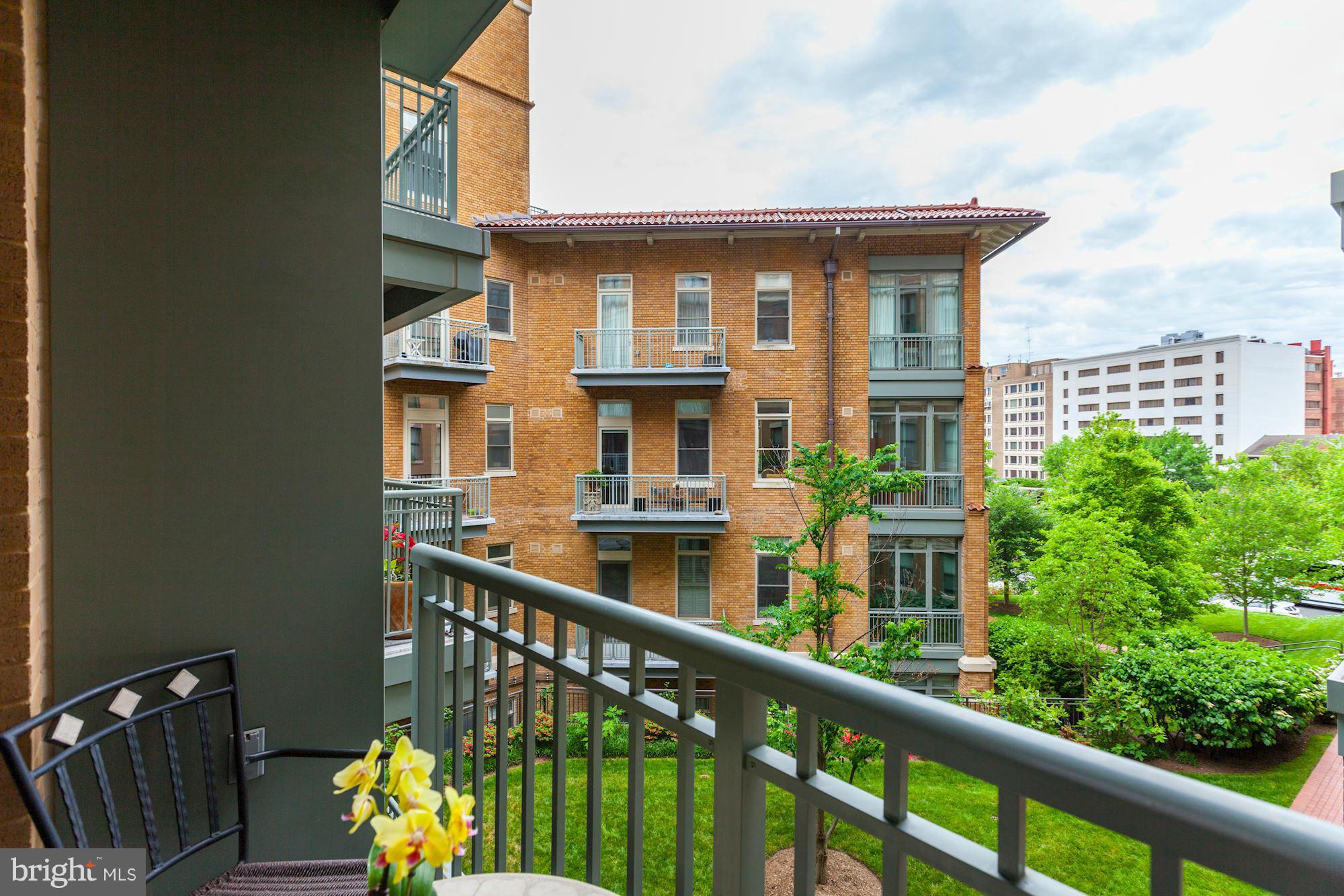 2425 L Street Northwest, Unit 412 Washington, DC 20037 - Photo 6 of 28 a view of a brick house with large windows and a table