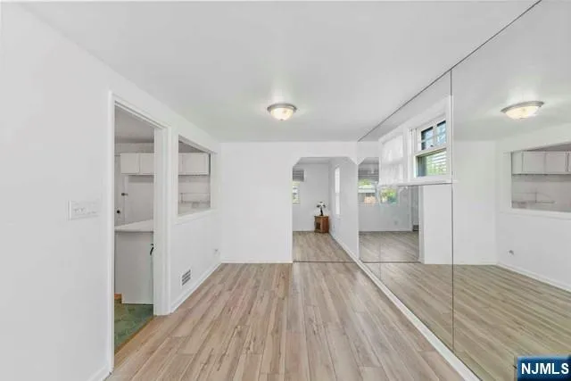 a view of a room with wooden floor