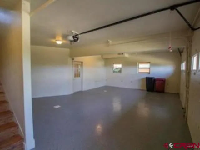 en empty room with windows and entrance