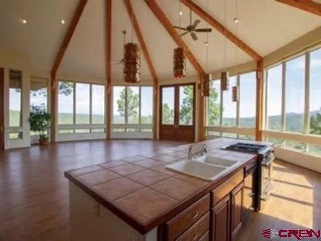 a view of a living room and kitchen with a large window
