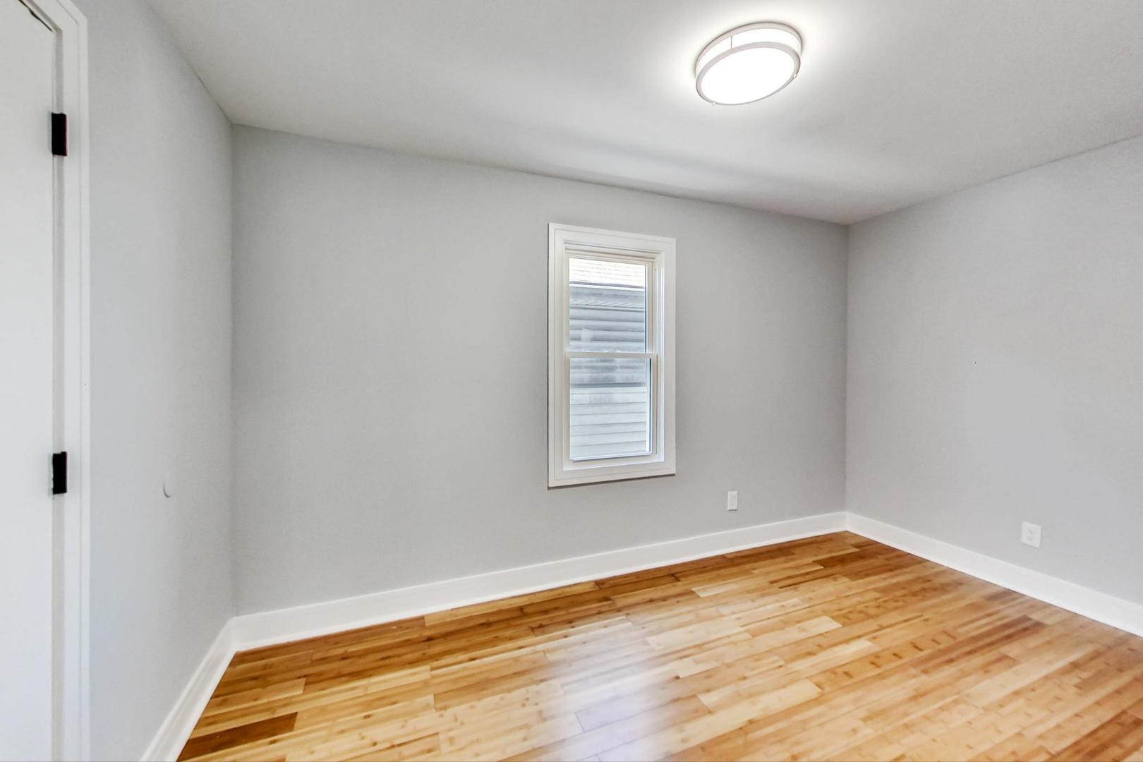 7640 West 63rd Place Summit, IL 60501 - Photo 12 of 29 an empty room with wooden floor
