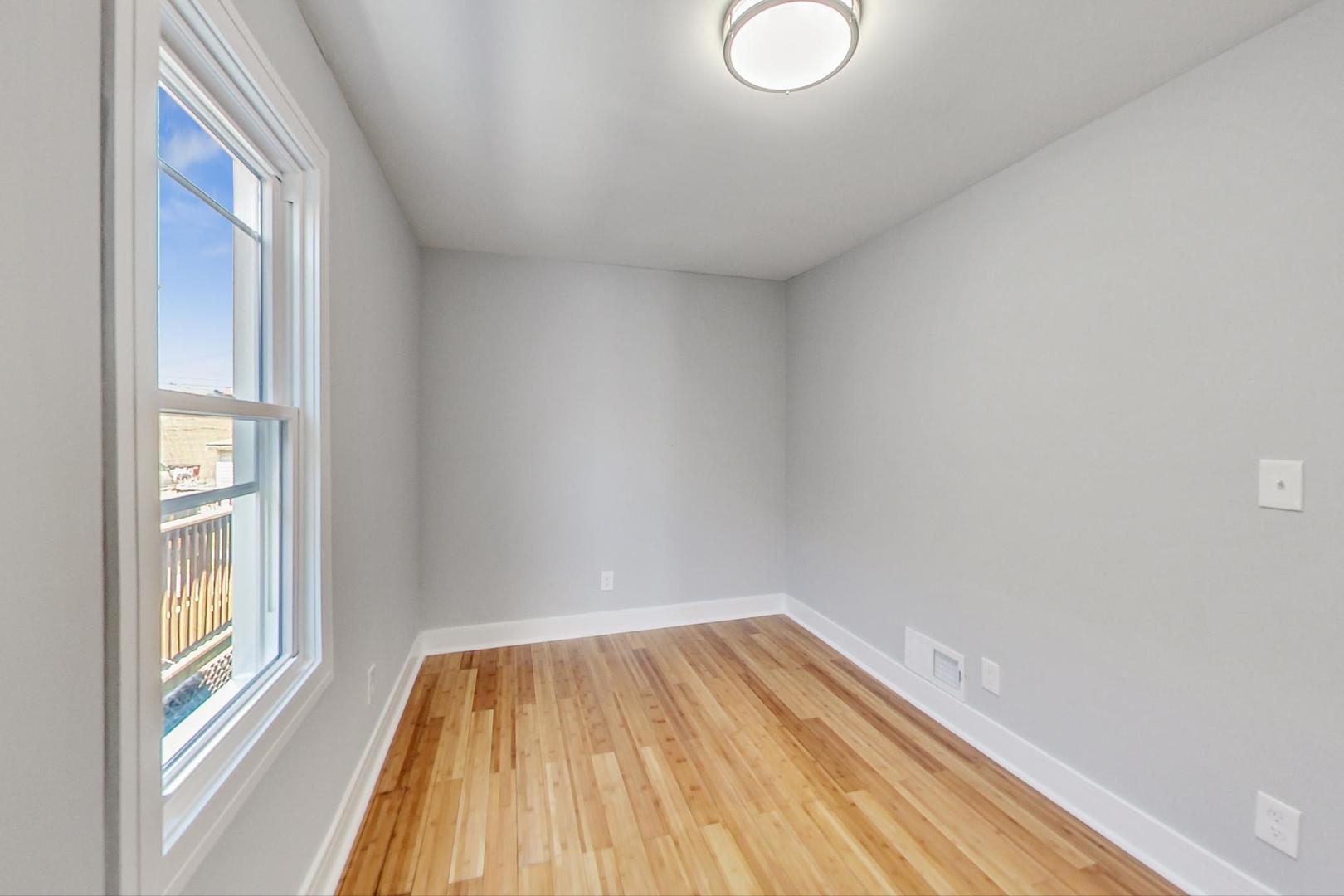 7640 West 63rd Place Summit, IL 60501 - Photo 13 of 29 a view of a room with wooden floor and window