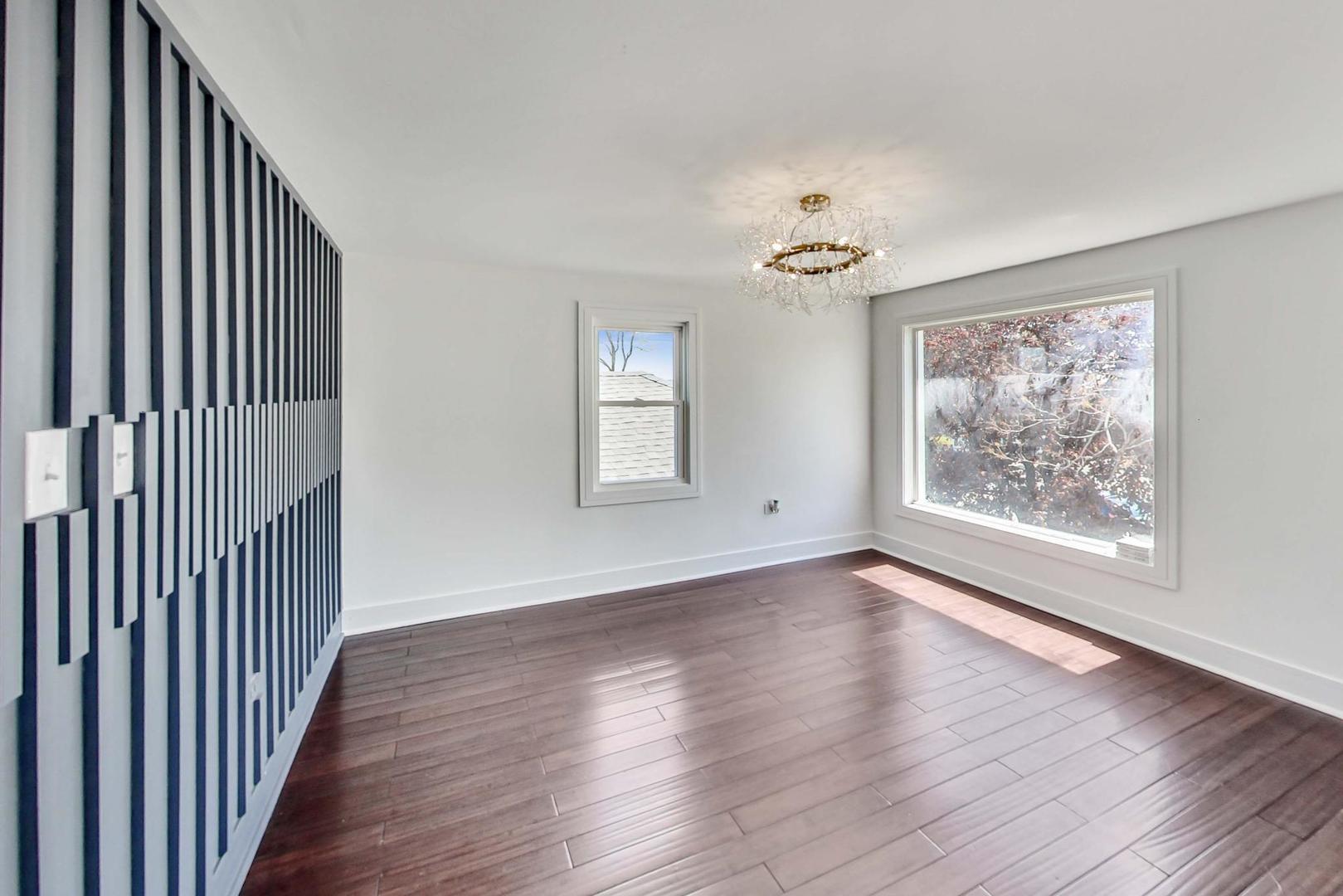 7640 West 63rd Place Summit, IL 60501 - Photo 16 of 29 a view of an empty room with wooden floor and a window