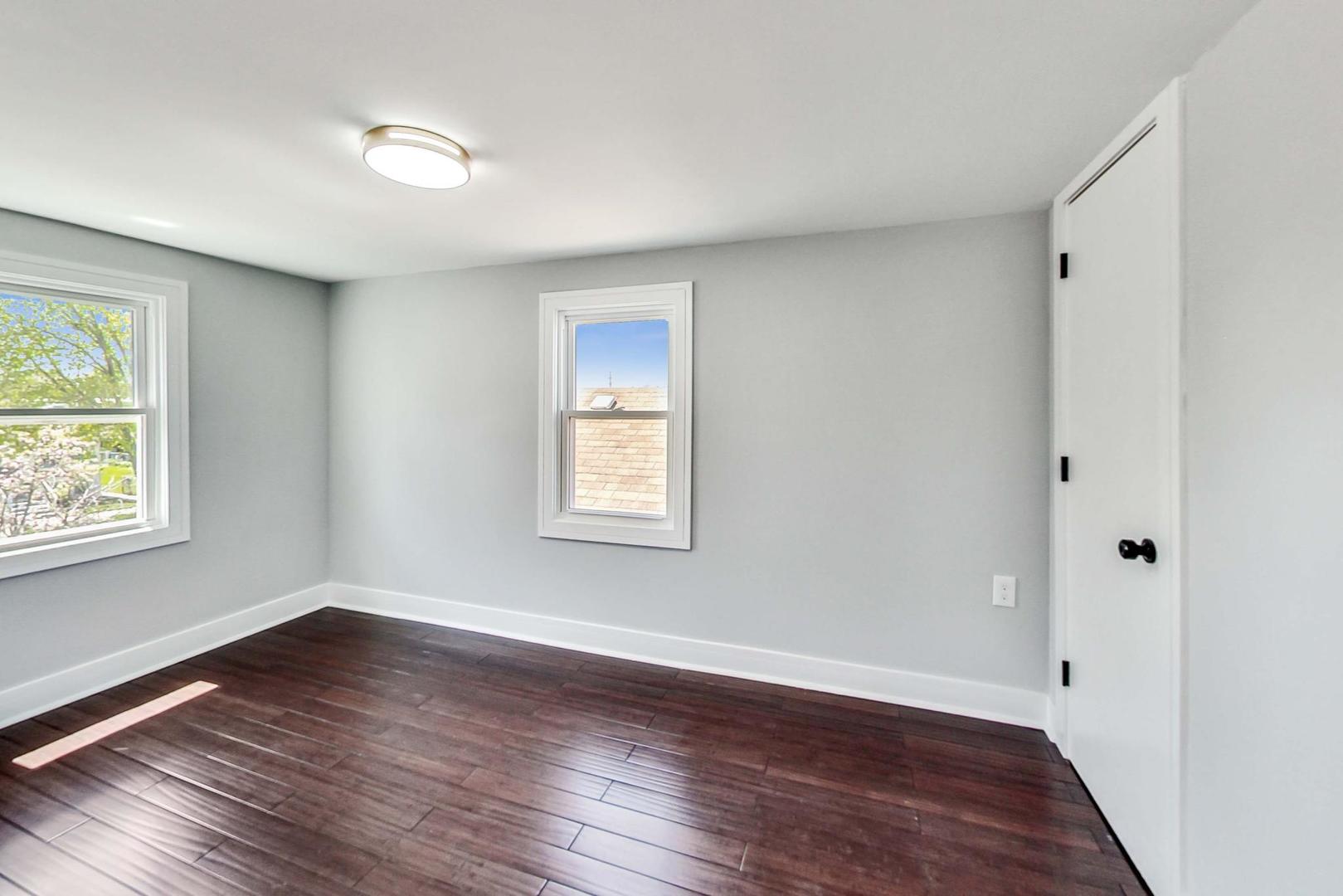 7640 West 63rd Place Summit, IL 60501 - Photo 20 of 29 a view of an empty room with wooden floor and a window