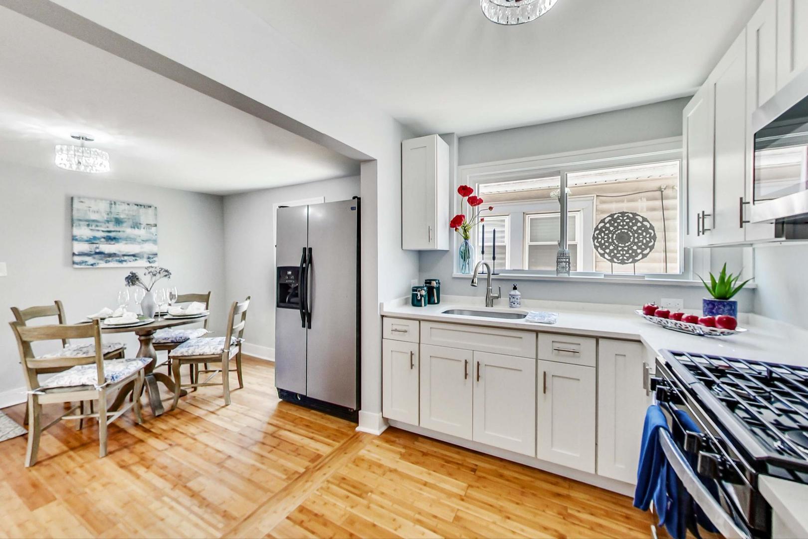 7640 West 63rd Place Summit, IL 60501 - Photo 6 of 29 a kitchen with a sink and chairs