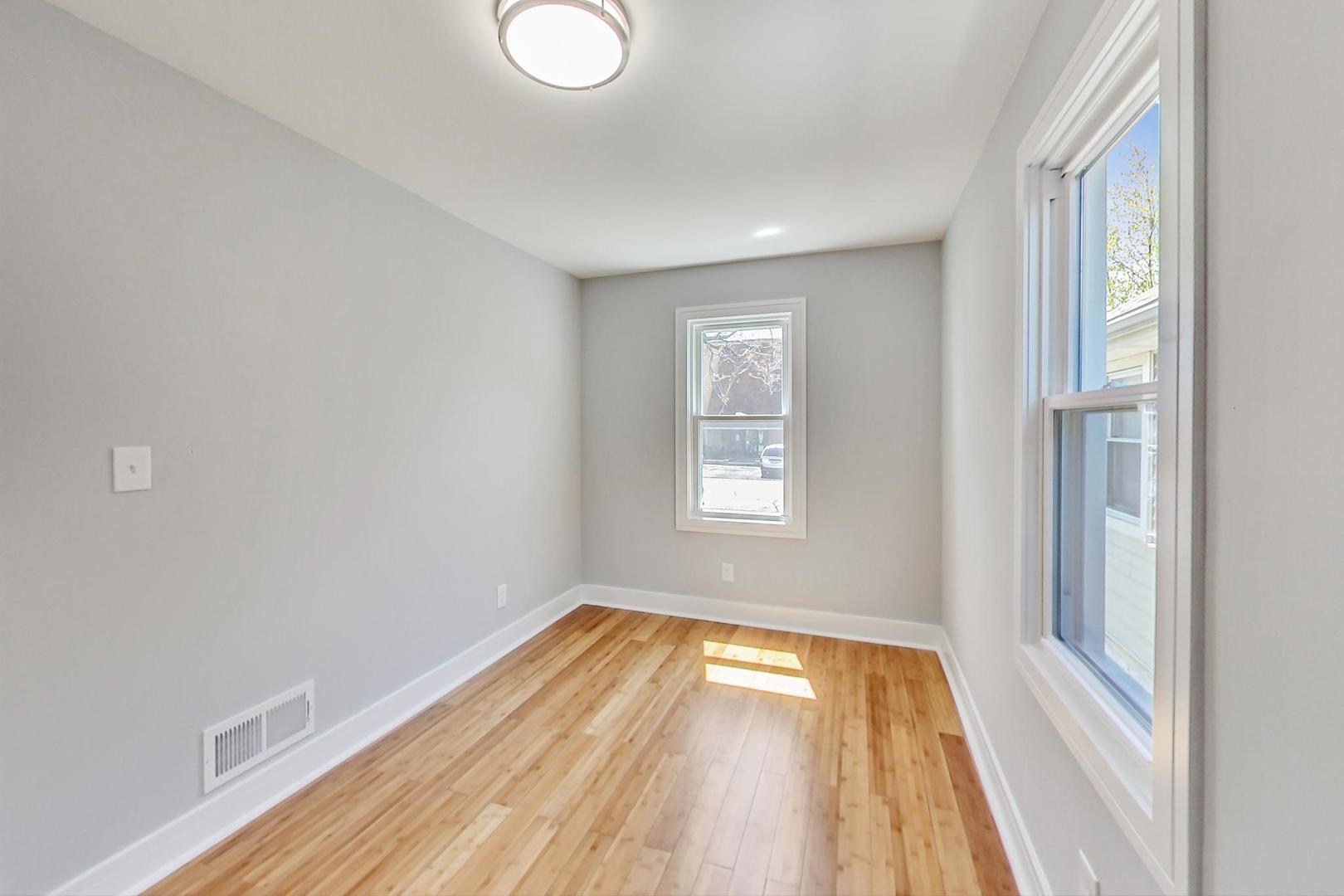 7640 West 63rd Place Summit, IL 60501 - Photo 10 of 29 a view of a room with wooden floor and window