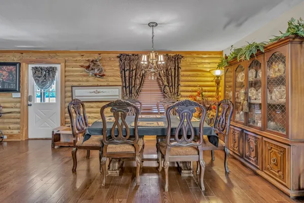 a view of a dining room with furniture wooden floor and chandelier