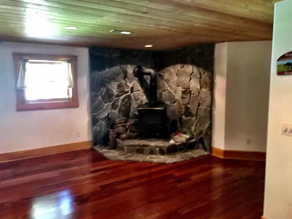 a view of water heater room with wooden floor