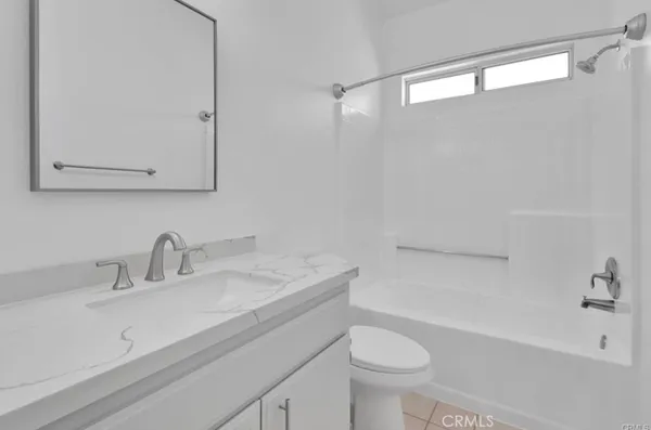 a bathroom with a sink a toilet and a bathtub