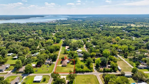 an aerial view of a houses with a yard