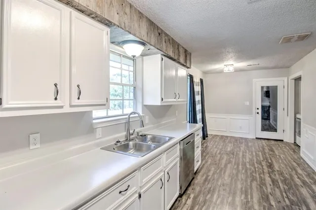 a kitchen with a sink and large mirror