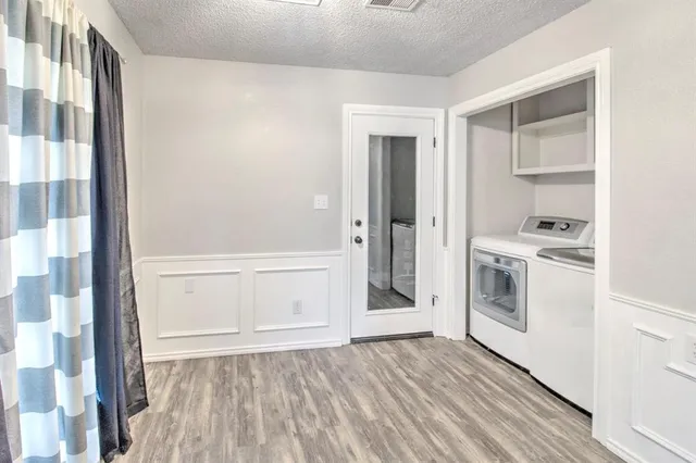 a view of kitchen with wooden floor and electronic appliances