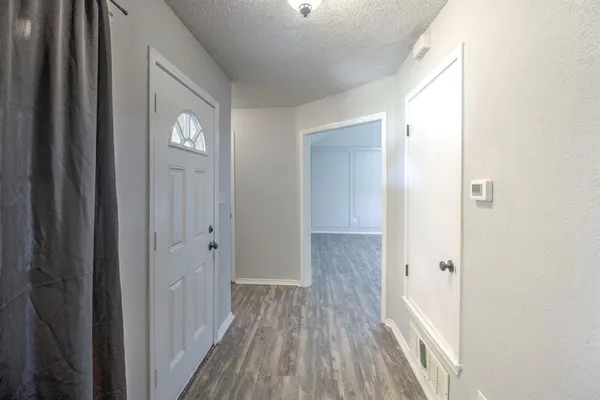 a view of a hallway with wooden floor