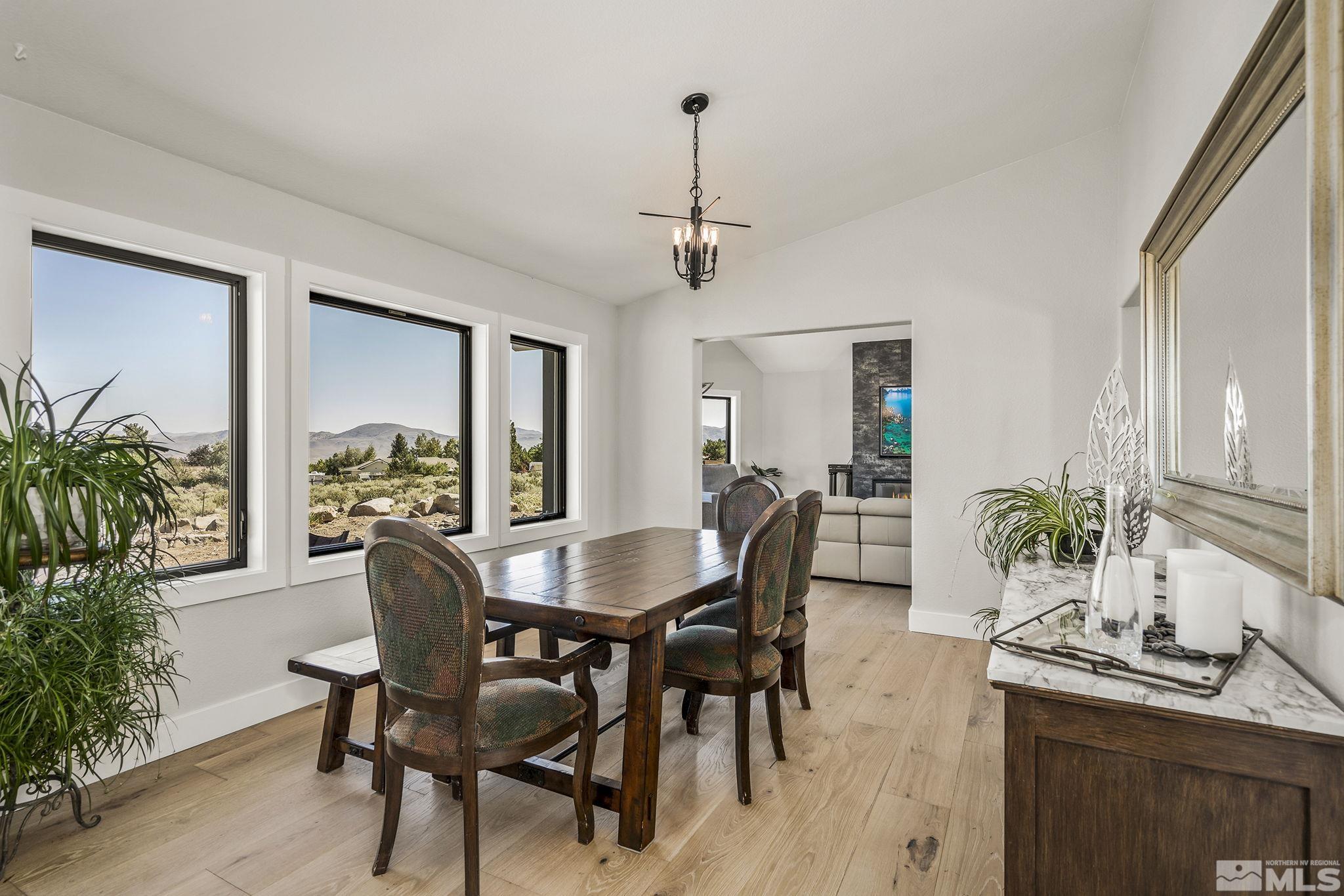 13285 Welcome Way Reno, NV 89511 - Photo 14 of 38 a view of a dining room with furniture window and wooden floor