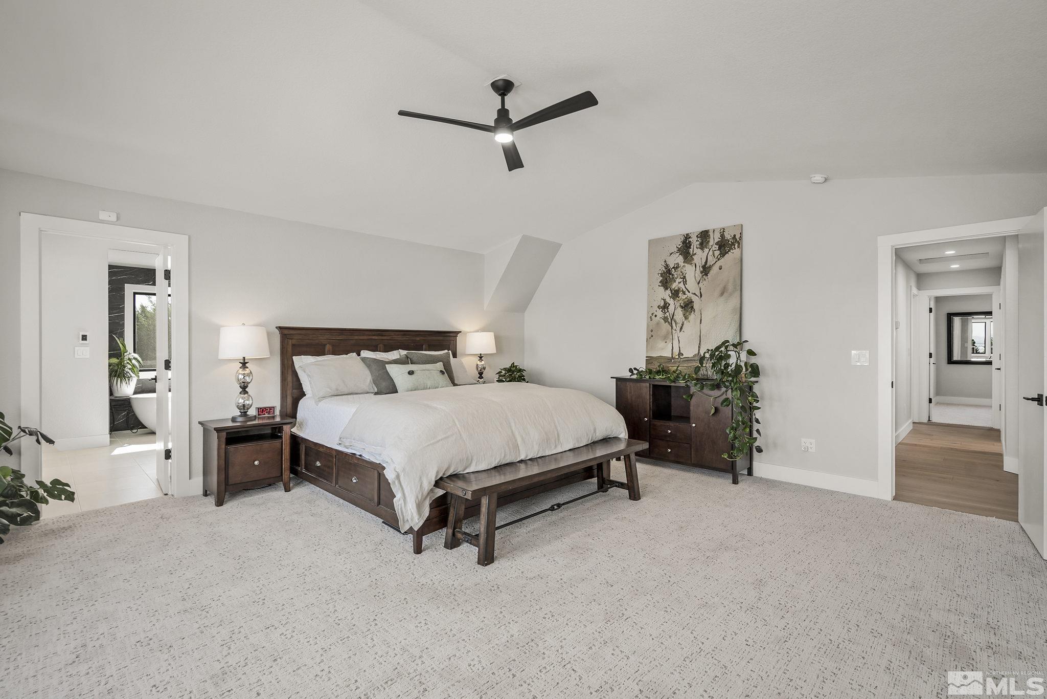 13285 Welcome Way Reno, NV 89511 - Photo 19 of 38 a spacious bedroom with a bed and a ceiling fan