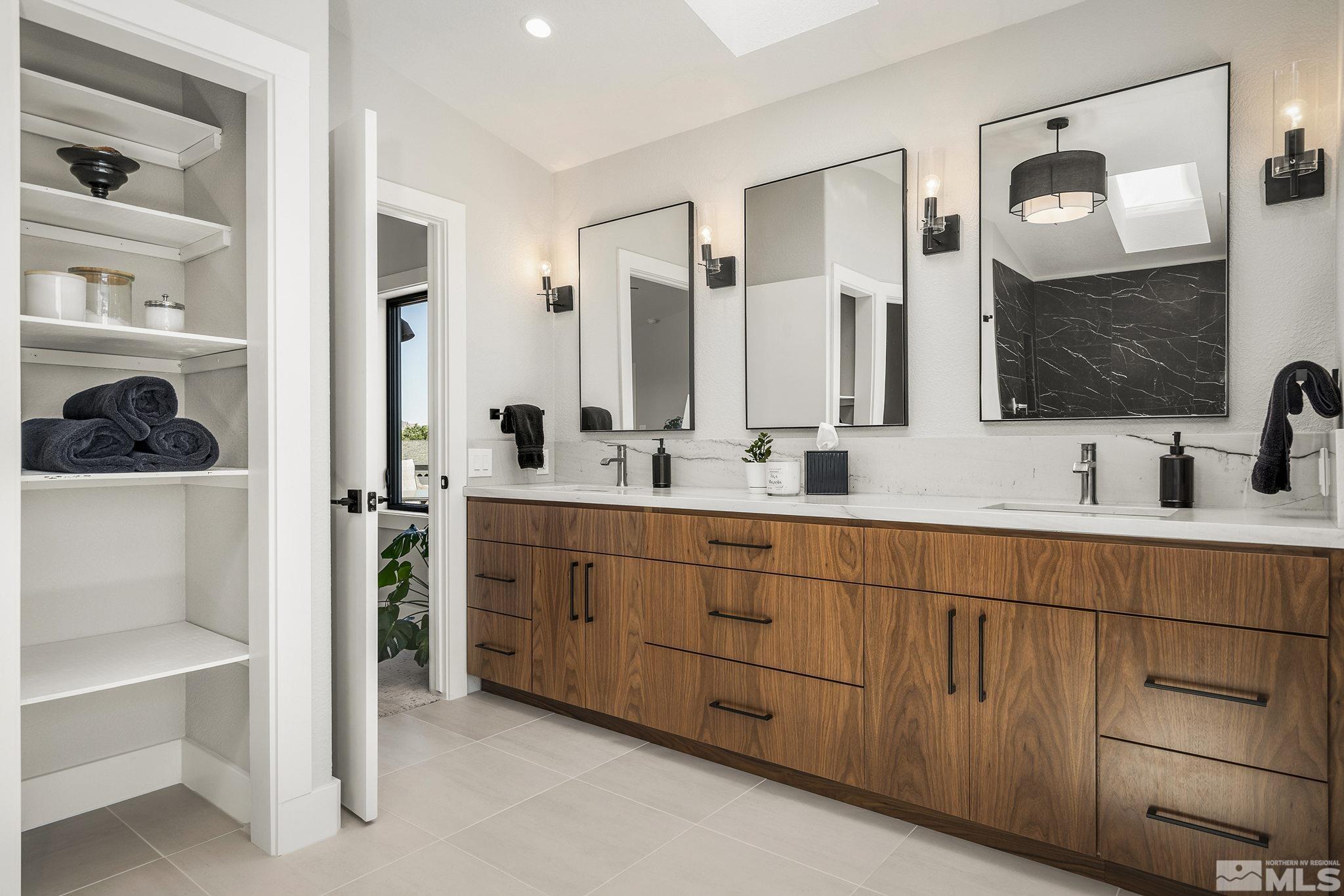 13285 Welcome Way Reno, NV 89511 - Photo 20 of 38 a spacious bathroom with a double vanity sink a mirror and shower