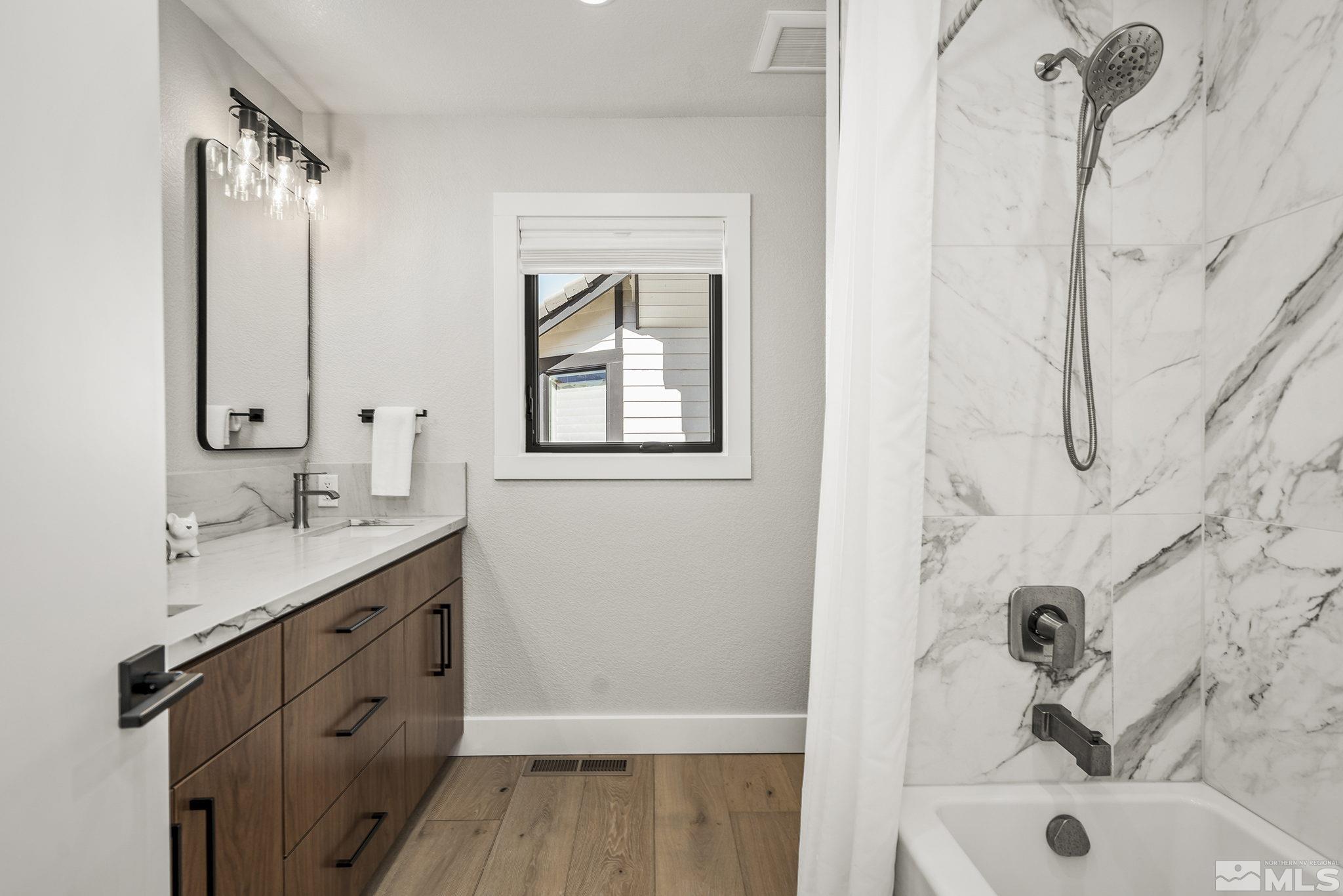 13285 Welcome Way Reno, NV 89511 - Photo 24 of 38 a bathroom with a tub sink and mirror