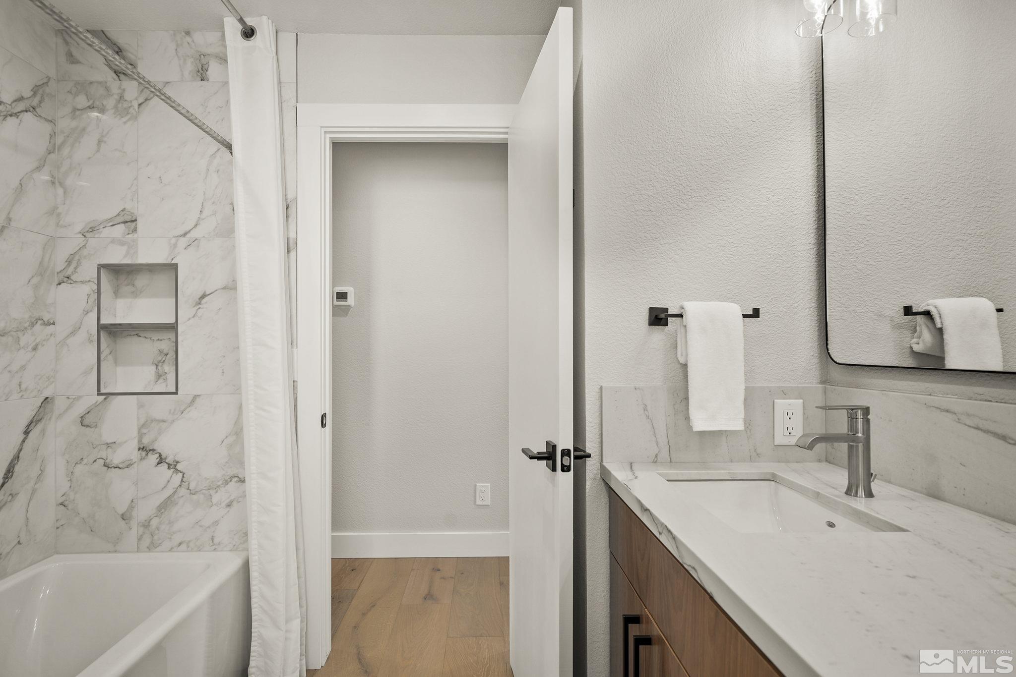 13285 Welcome Way Reno, NV 89511 - Photo 25 of 38 a bathroom with a tub sink and mirror