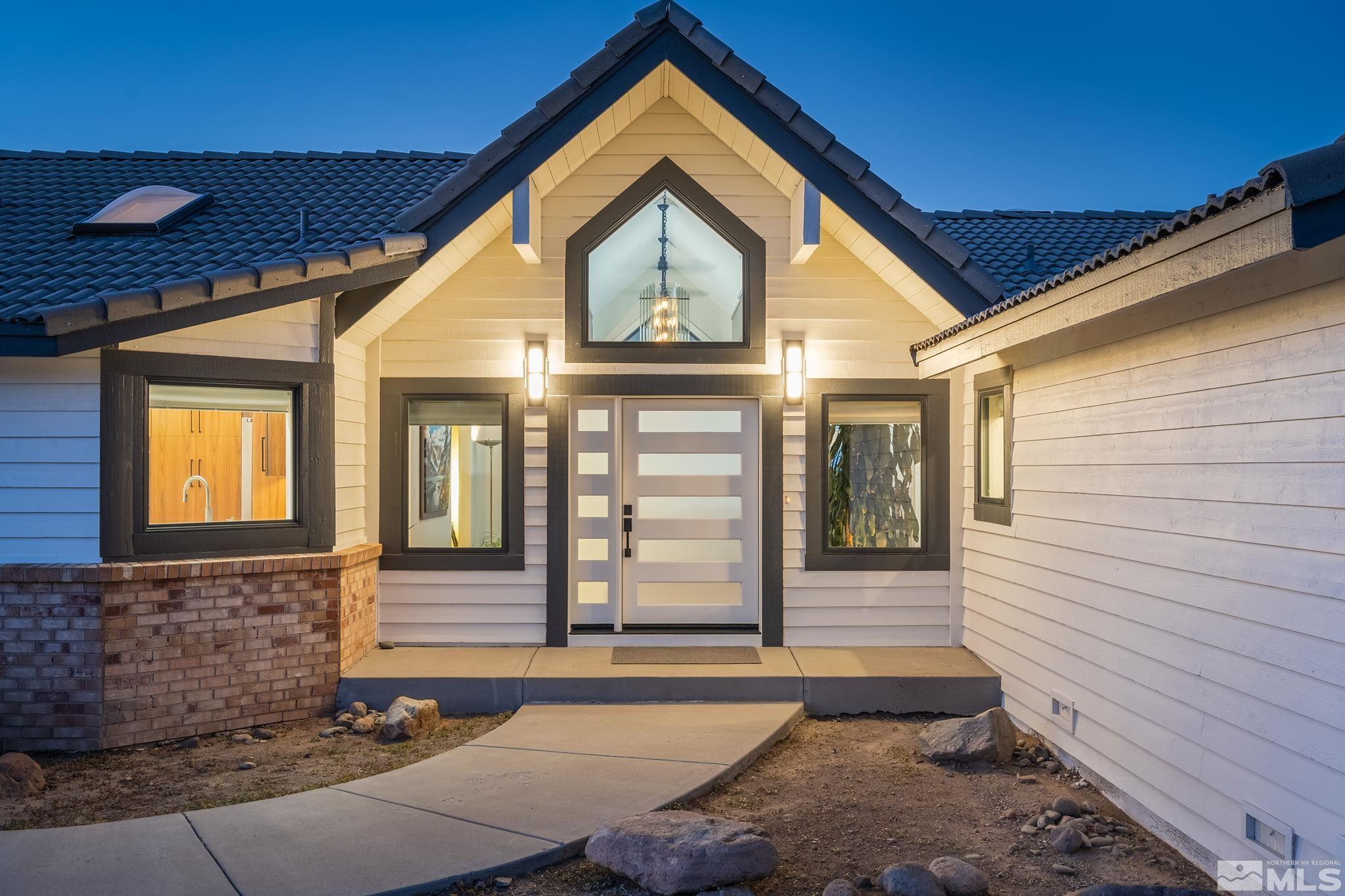 13285 Welcome Way Reno, NV 89511 - Photo 3 of 38 a front view of a house with a yard