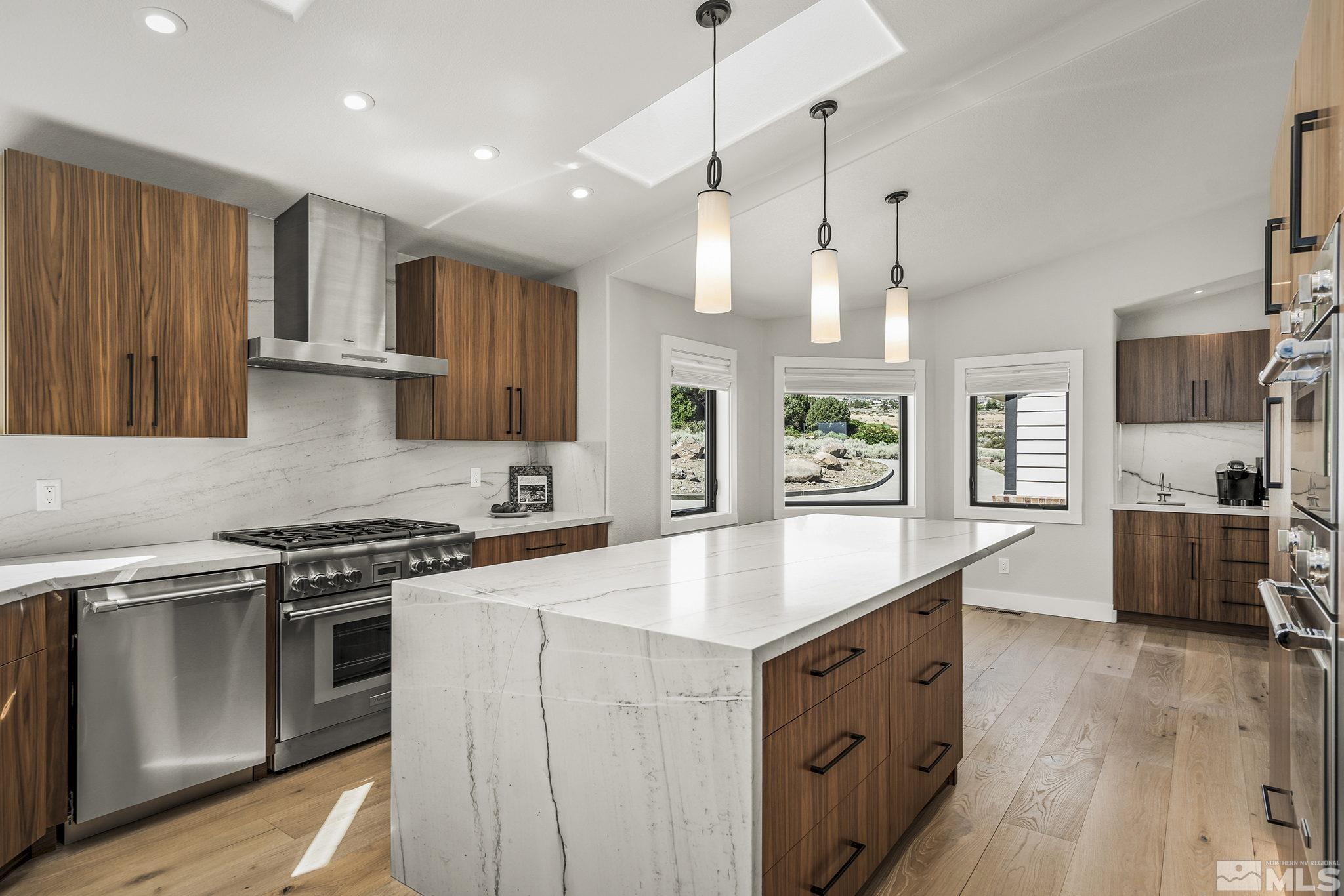 13285 Welcome Way Reno, NV 89511 - Photo 9 of 38 a kitchen with stainless steel appliances granite countertop a sink stove and wooden floor