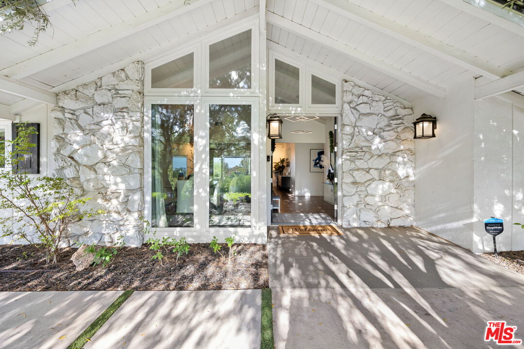 25021 Jim Bridger Road Hidden Hills, CA 91302 - Photo 1 of 30 a view of a brick house with windows