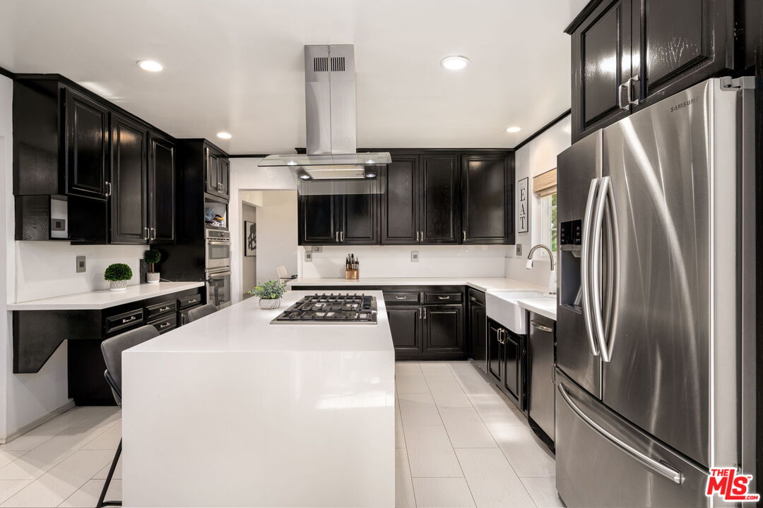 25021 Jim Bridger Road Hidden Hills, CA 91302 - Photo 13 of 30 a kitchen with stainless steel appliances a refrigerator sink and stove