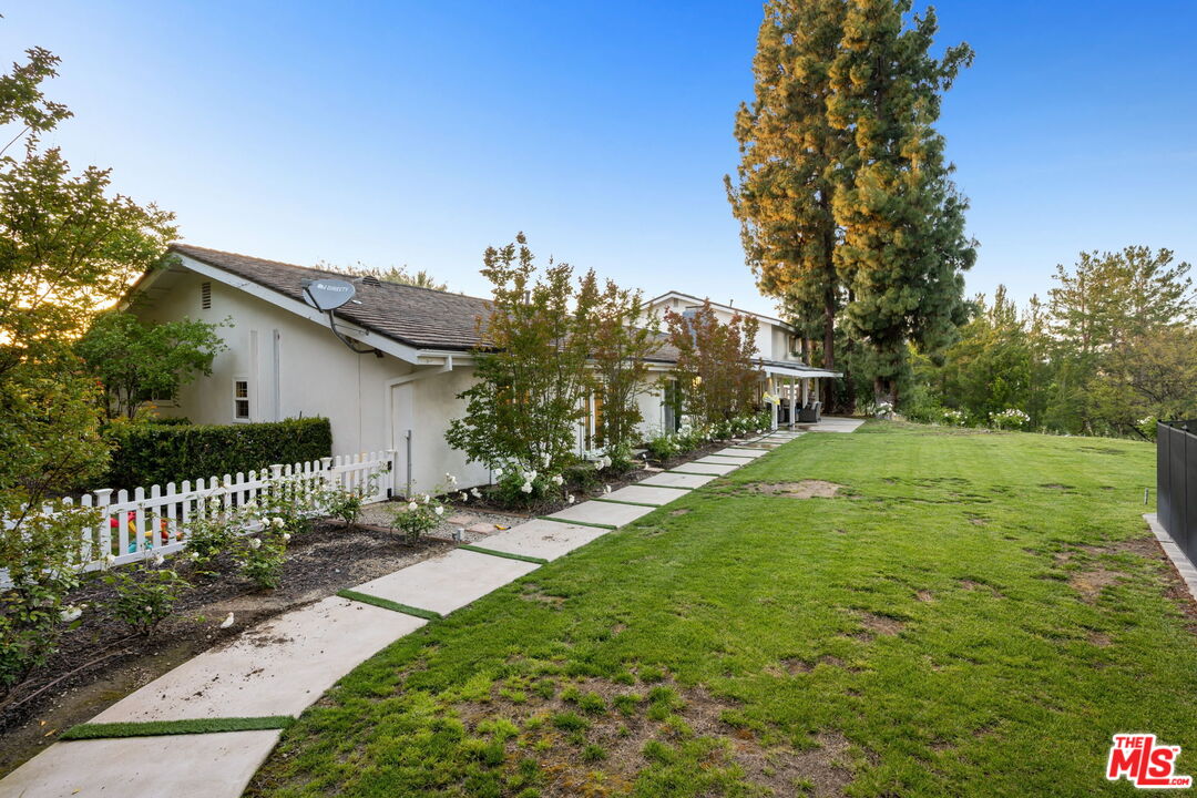 25021 Jim Bridger Road Hidden Hills, CA 91302 - Photo 26 of 30 a view of a porch with a yard