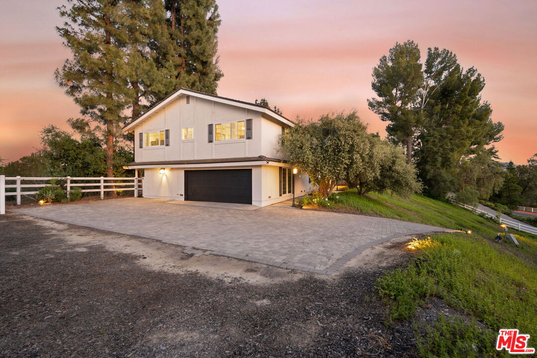 25021 Jim Bridger Road Hidden Hills, CA 91302 - Photo 29 of 30 a front view of a house with a yard and garage