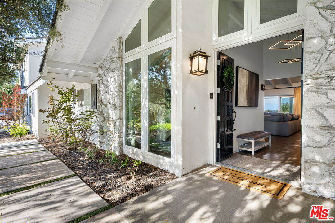 25021 Jim Bridger Road Hidden Hills, CA 91302 - Photo 3 of 30 a view of a chairs and a table in the patio