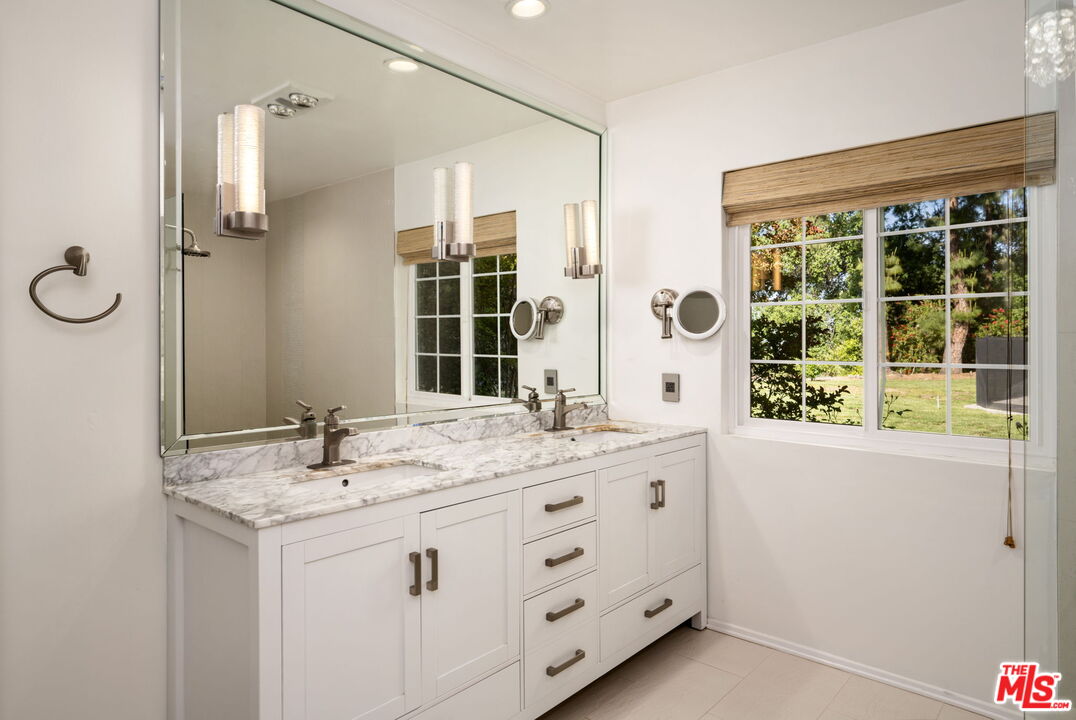 25021 Jim Bridger Road Hidden Hills, CA 91302 - Photo 8 of 30 a bathroom with a sink double vanity and a shower