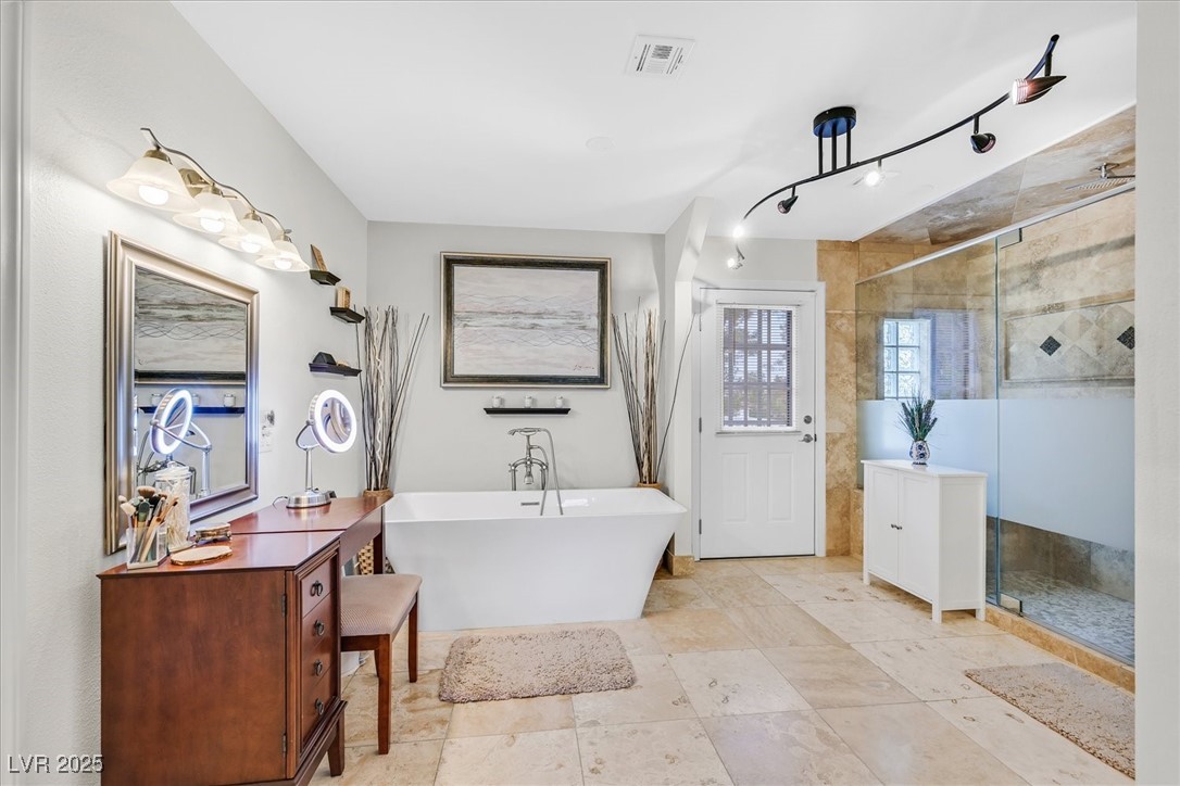18 Hummingbird Circle Henderson, NV 89014 - Photo 20 of 39 Bathroom featuring a soaking tub, a shower stall, and vanity