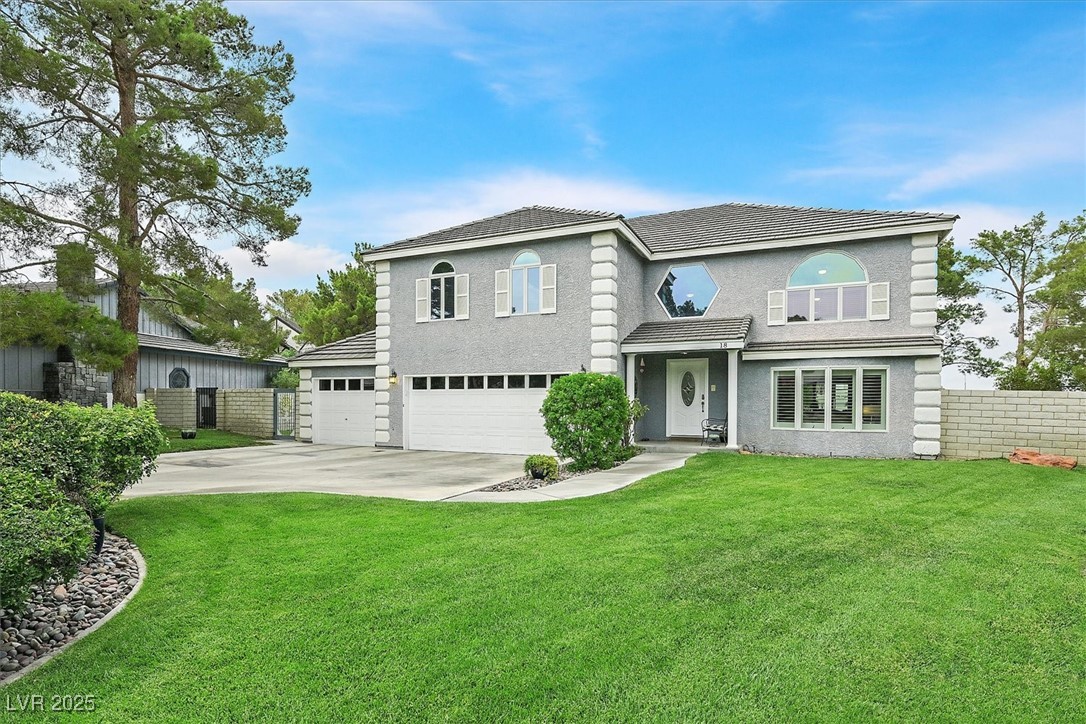 18 Hummingbird Circle Henderson, NV 89014 - Photo 2 of 39 View of front of house featuring concrete driveway, a garage, and stucco siding