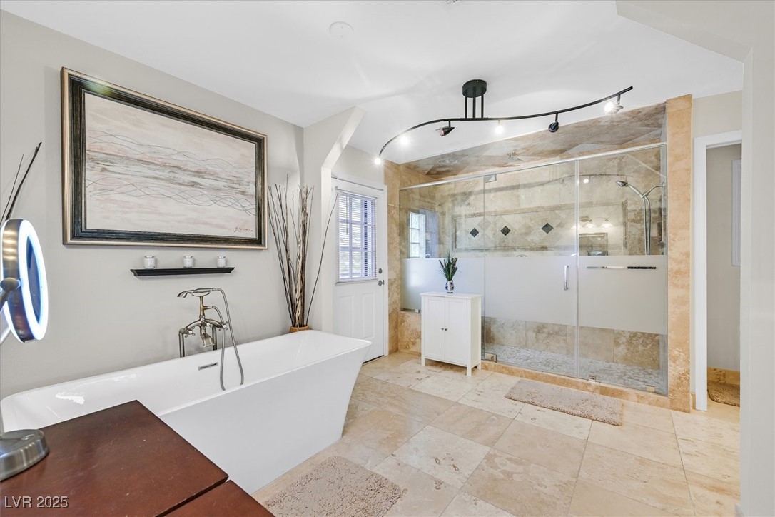 18 Hummingbird Circle Henderson, NV 89014 - Photo 21 of 39 Bathroom featuring a freestanding tub and a stall shower