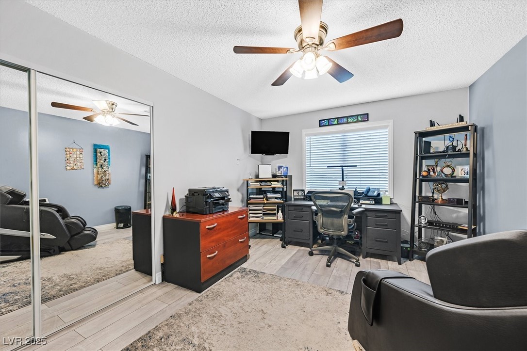 18 Hummingbird Circle Henderson, NV 89014 - Photo 26 of 39 Office featuring ceiling fan, light wood-style flooring, and a textured ceiling