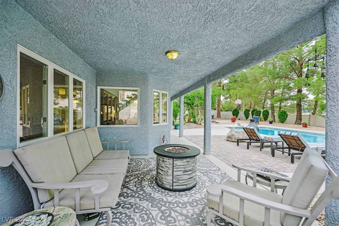 18 Hummingbird Circle Henderson, NV 89014 - Photo 36 of 39 View of patio featuring an outdoor pool and an outdoor living space with a fire pit