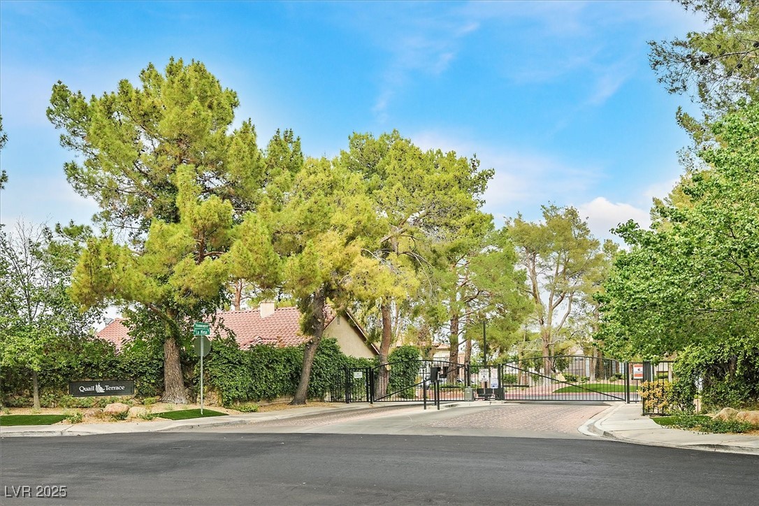 18 Hummingbird Circle Henderson, NV 89014 - Photo 39 of 39 View of asphalt street with sidewalks, a gated entry, a gate, and curbs