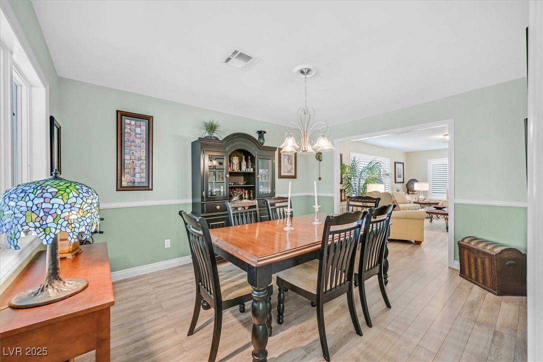 18 Hummingbird Circle Henderson, NV 89014 - Photo 8 of 39 Dining space with light wood-style floors and a chandelier