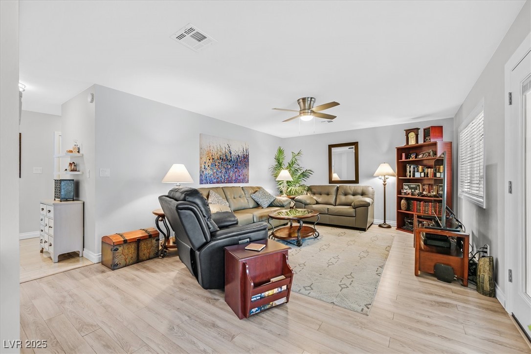 18 Hummingbird Circle Henderson, NV 89014 - Photo 9 of 39 Living area featuring light wood finished floors and ceiling fan