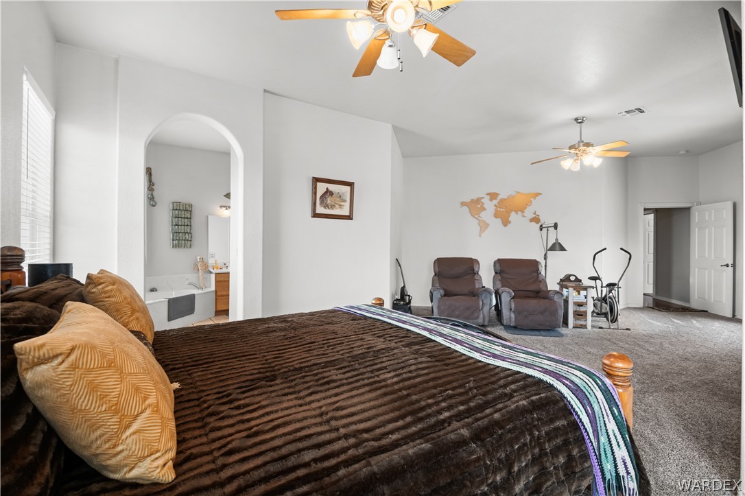2898 Mountain Trail Road Kingman, AZ 86401 - Photo 13 of 75 a bedroom with double bed and a chandelier