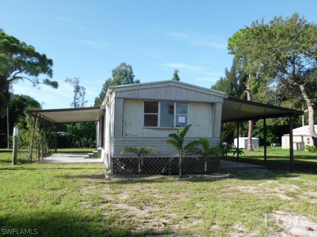 7491 Pinehurst Road Bokeelia, FL 33922 - Photo 1 of 7 a front view of a house with garden