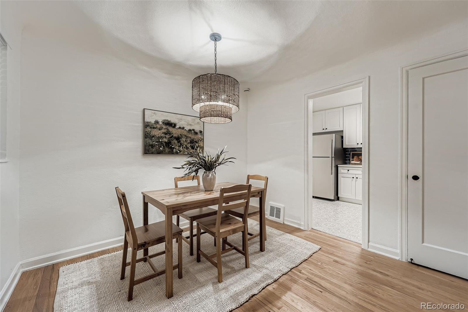 2985 Ivanhoe Street Denver, CO 80207 - Photo 6 of 25 a view of a dining room with furniture and wooden floor